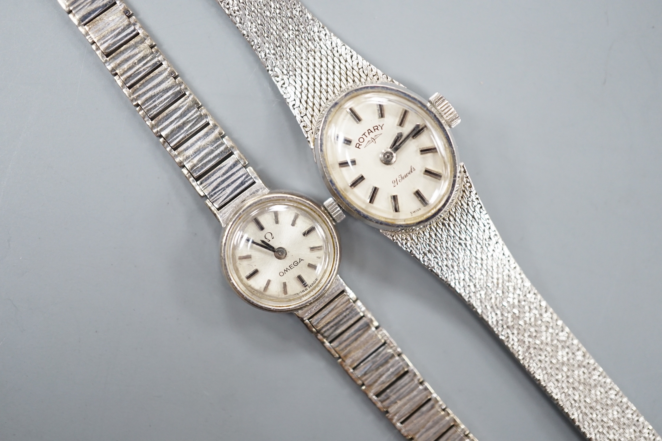 A lady's 9ct white gold Rotary manual wind wrist watch and a similar Omega wrist watch, gross 31.5 grams.